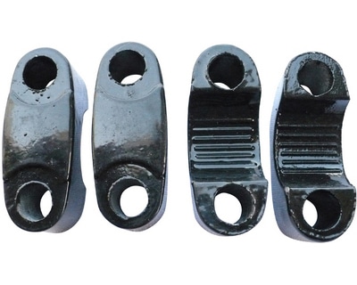 A set of four black Handle Bracket 3050 (HBB-6) (MGM-QA008) rubber clamps for holding and bracketing objects.